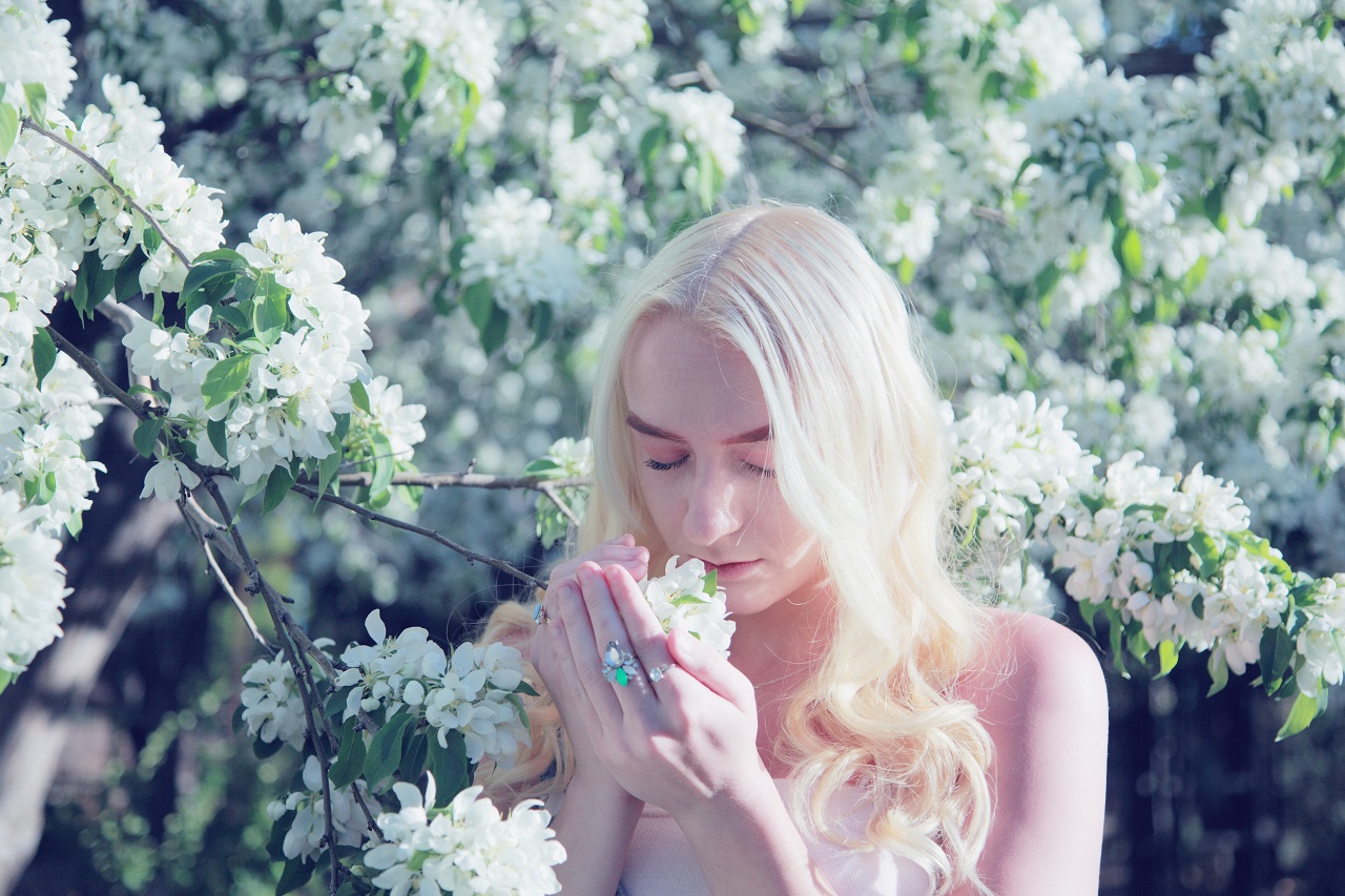 lady smelling flowers woman smelling flowers