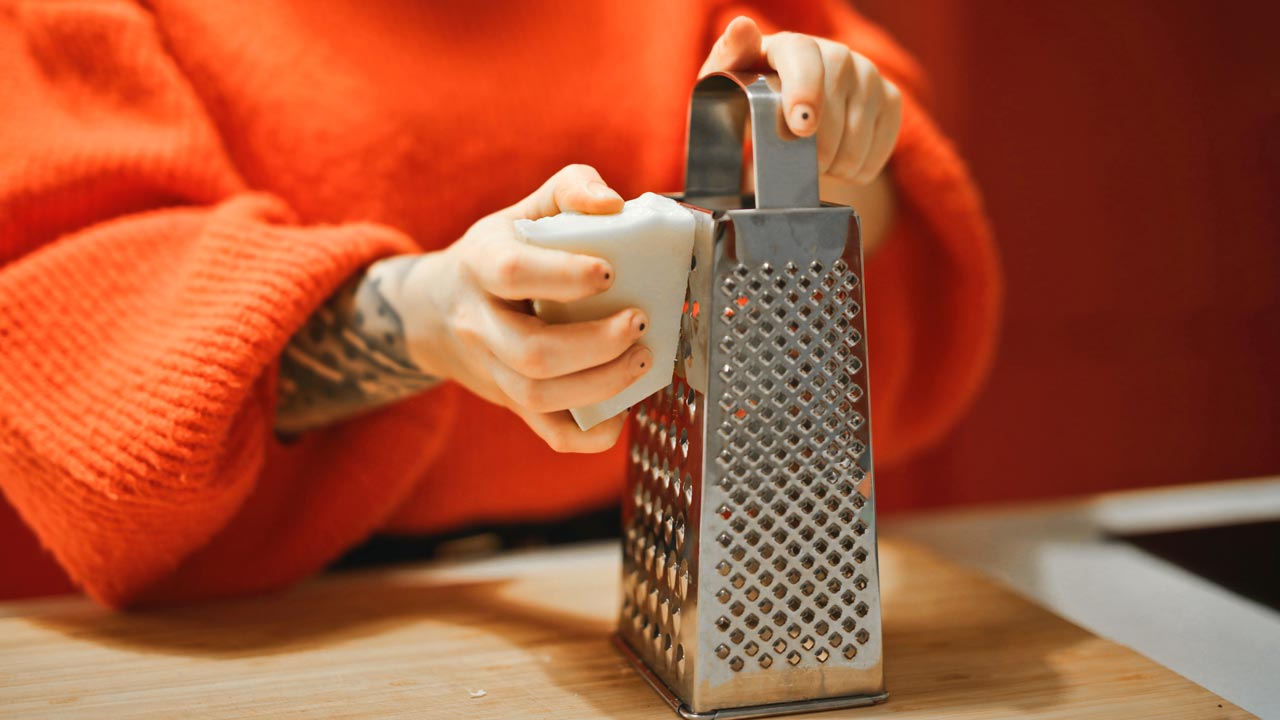 women is grating cheese