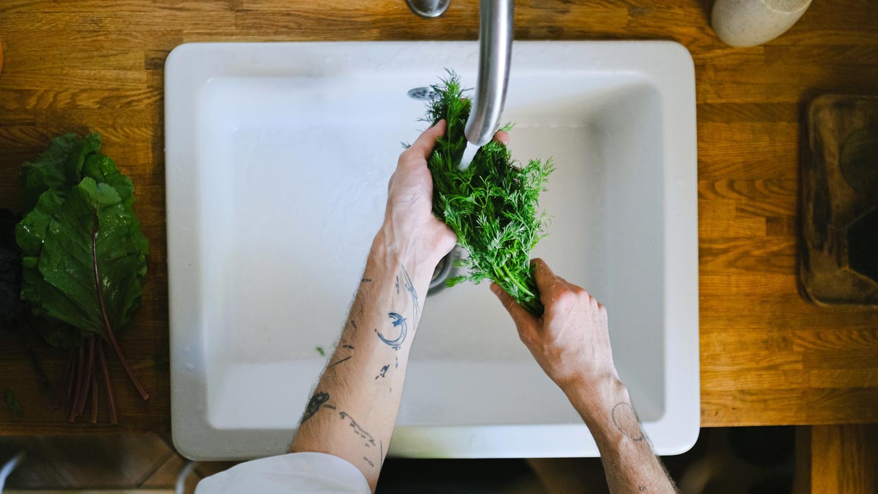 man washing vegetable