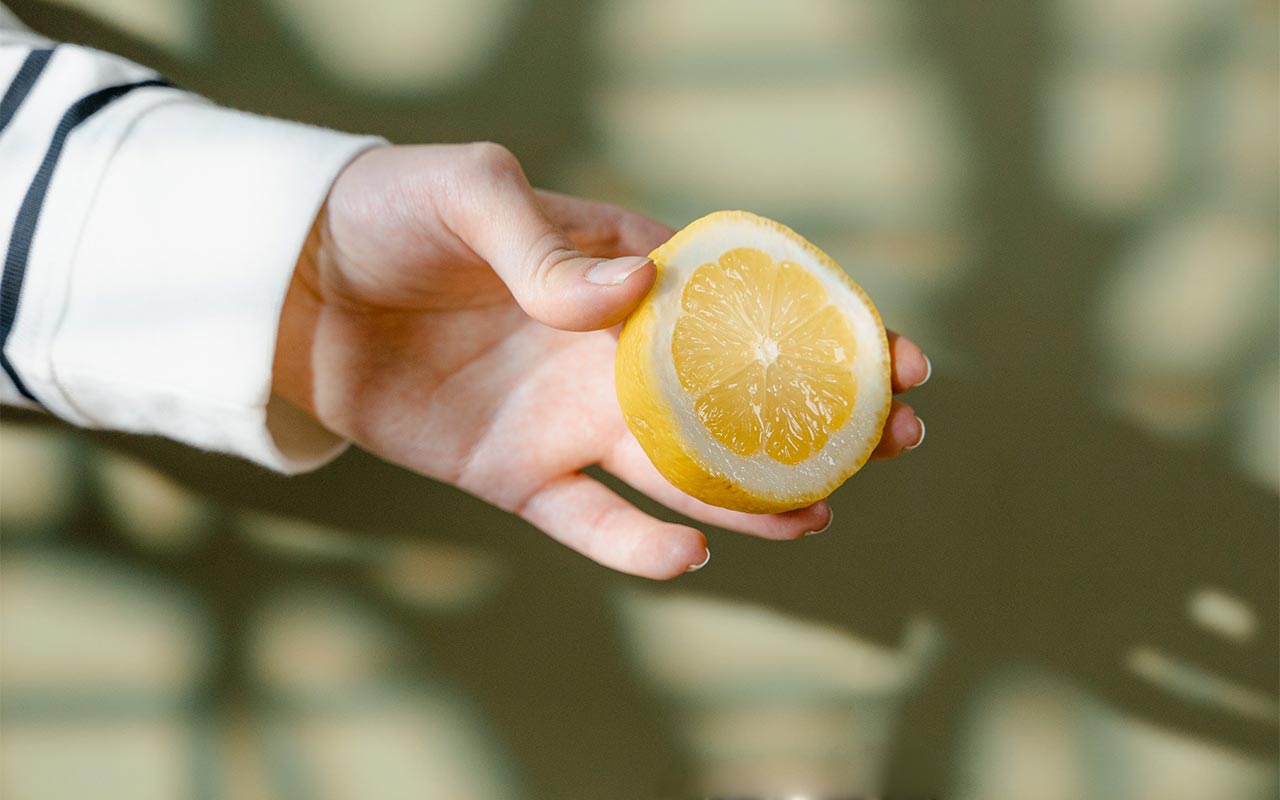 hand holding a lemon
