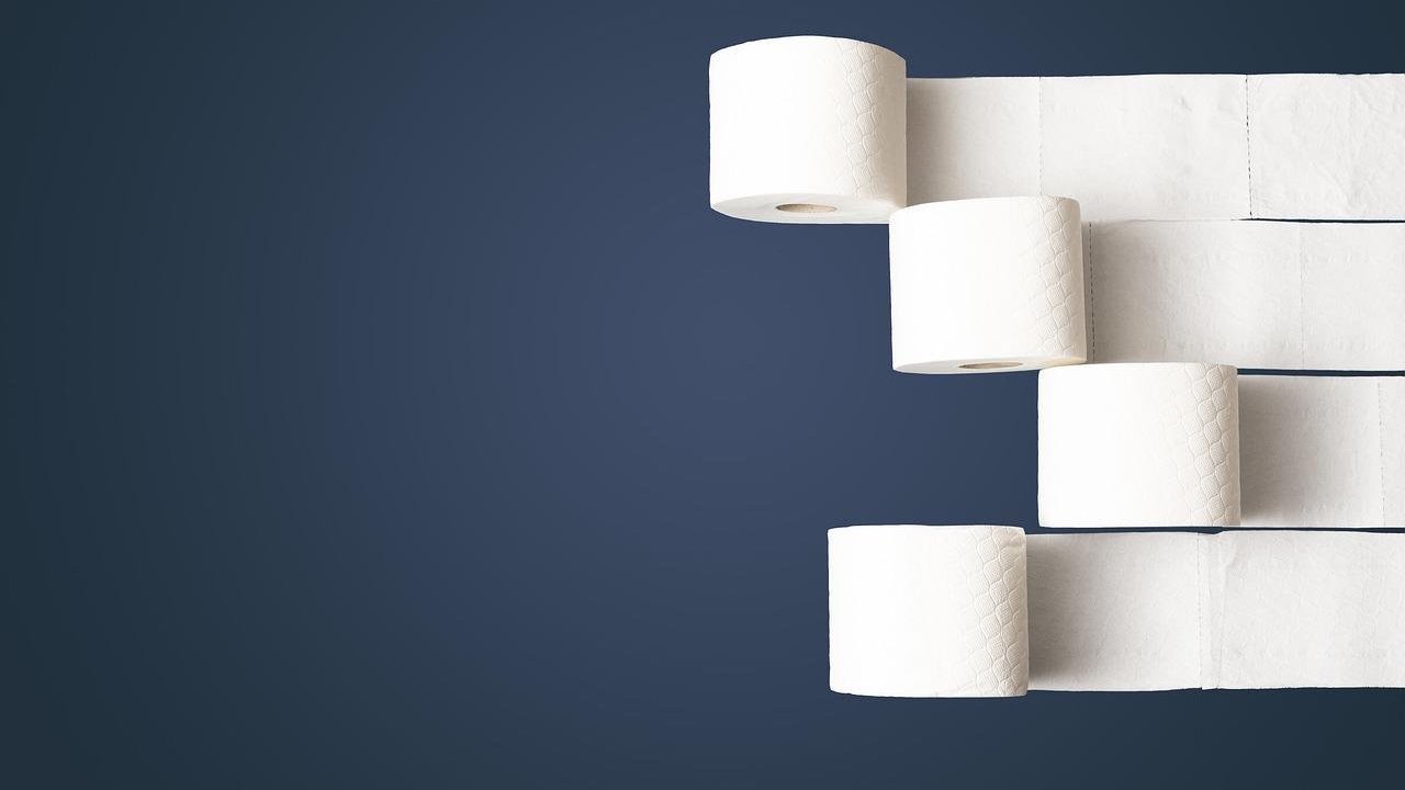 soft white toilet paper roll on dark background