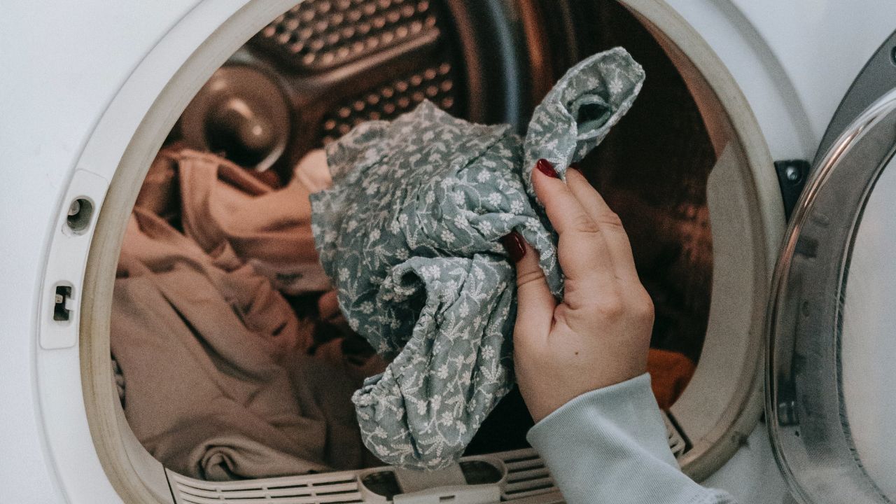 putting dirty clothes in the machine