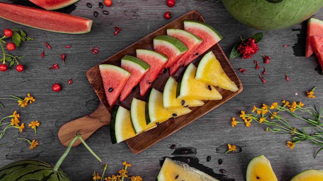 slices of yellow and red watermelon in a tray