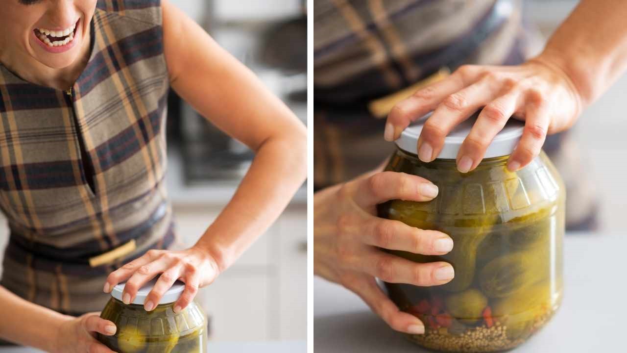 a woman is failing at opening a tight jar in the picture