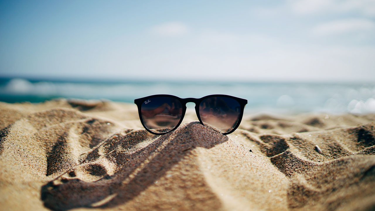 a pair of sunglasses on the beach