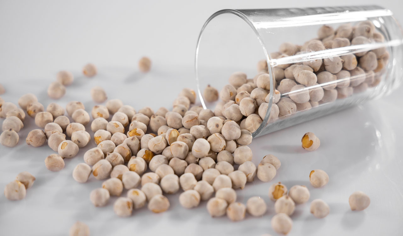 Chickpeas with shells that poured out from a glass