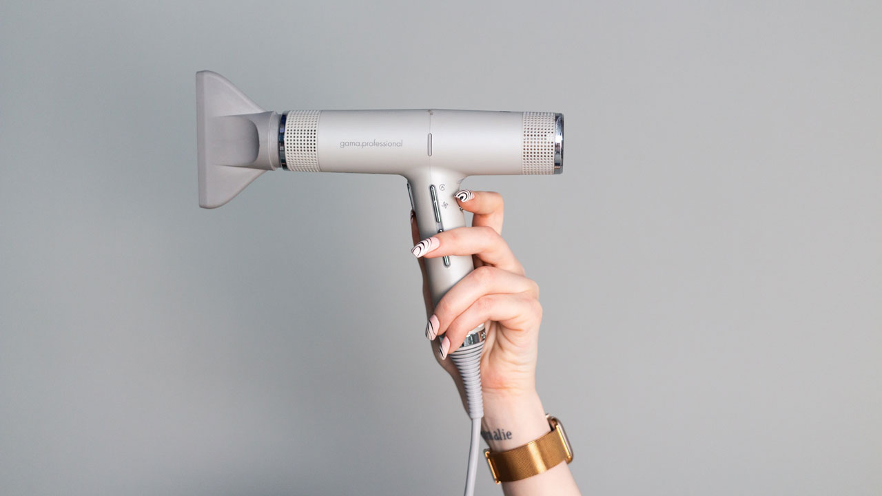 a person holding a hair dryer