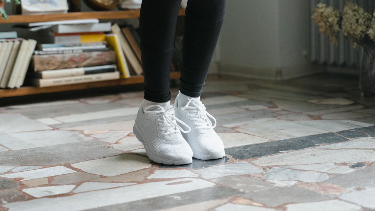 a person standing on the tiled floor