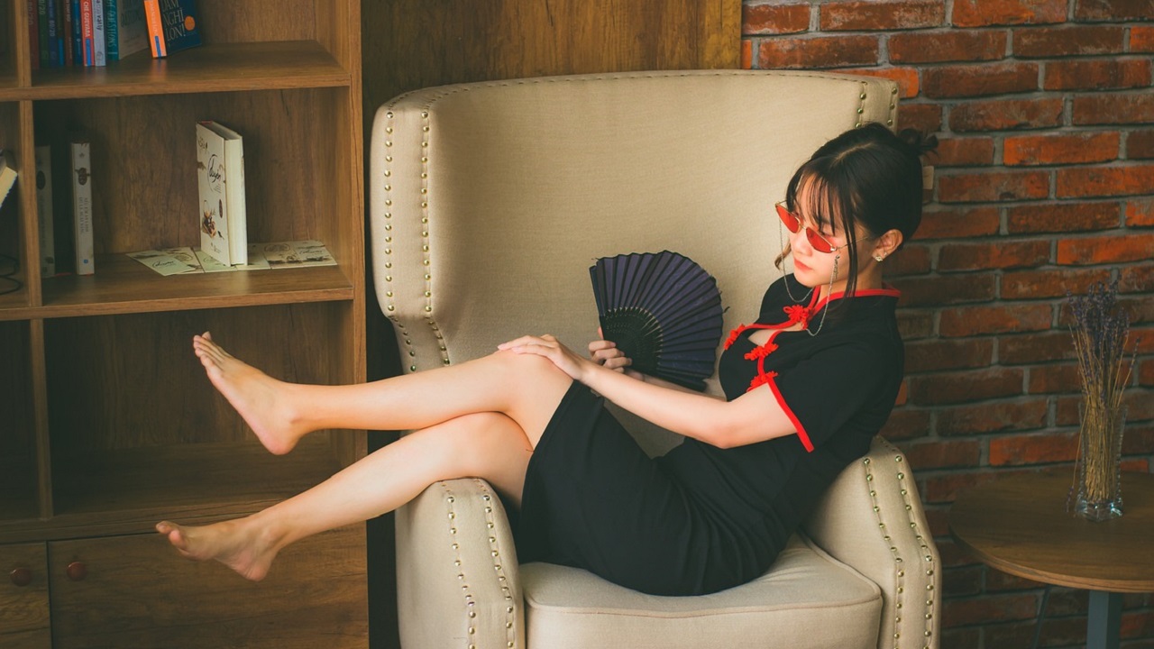 a girl is lying down on a sofa