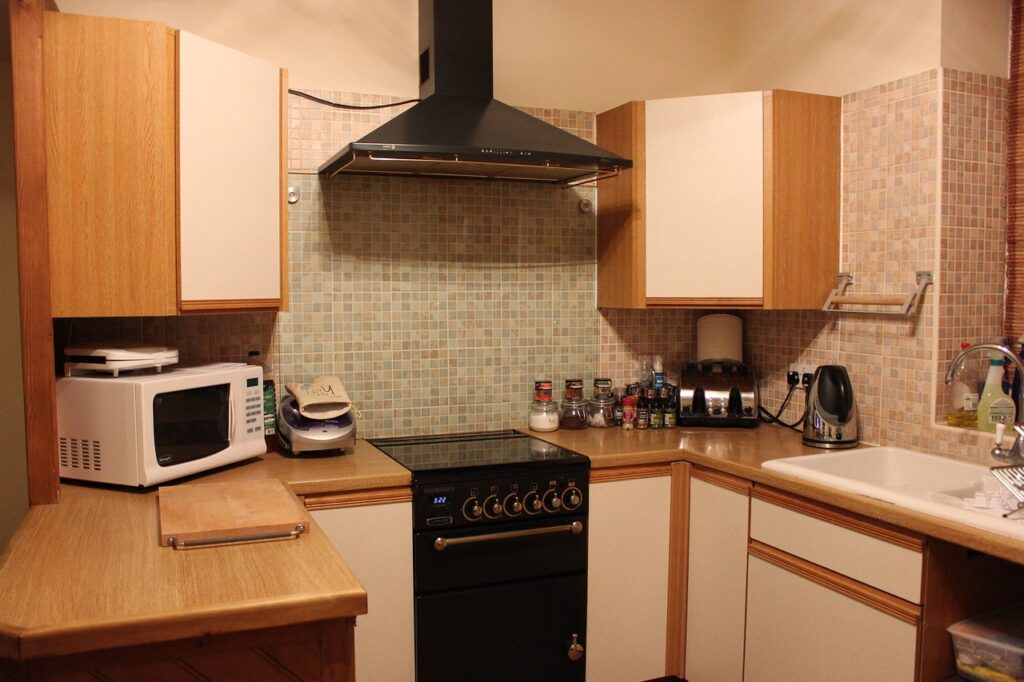 an oven is in the kitchen with clean hob knobs