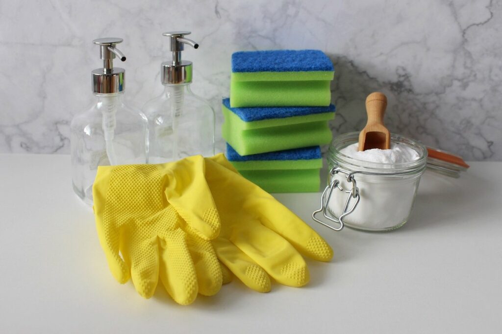 spray bottles, gloves, sponge and baking soda. things to use for cleaning bathroom