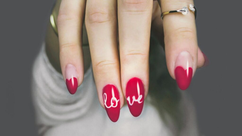 a girl showing her nails with beautiful nail polish on it