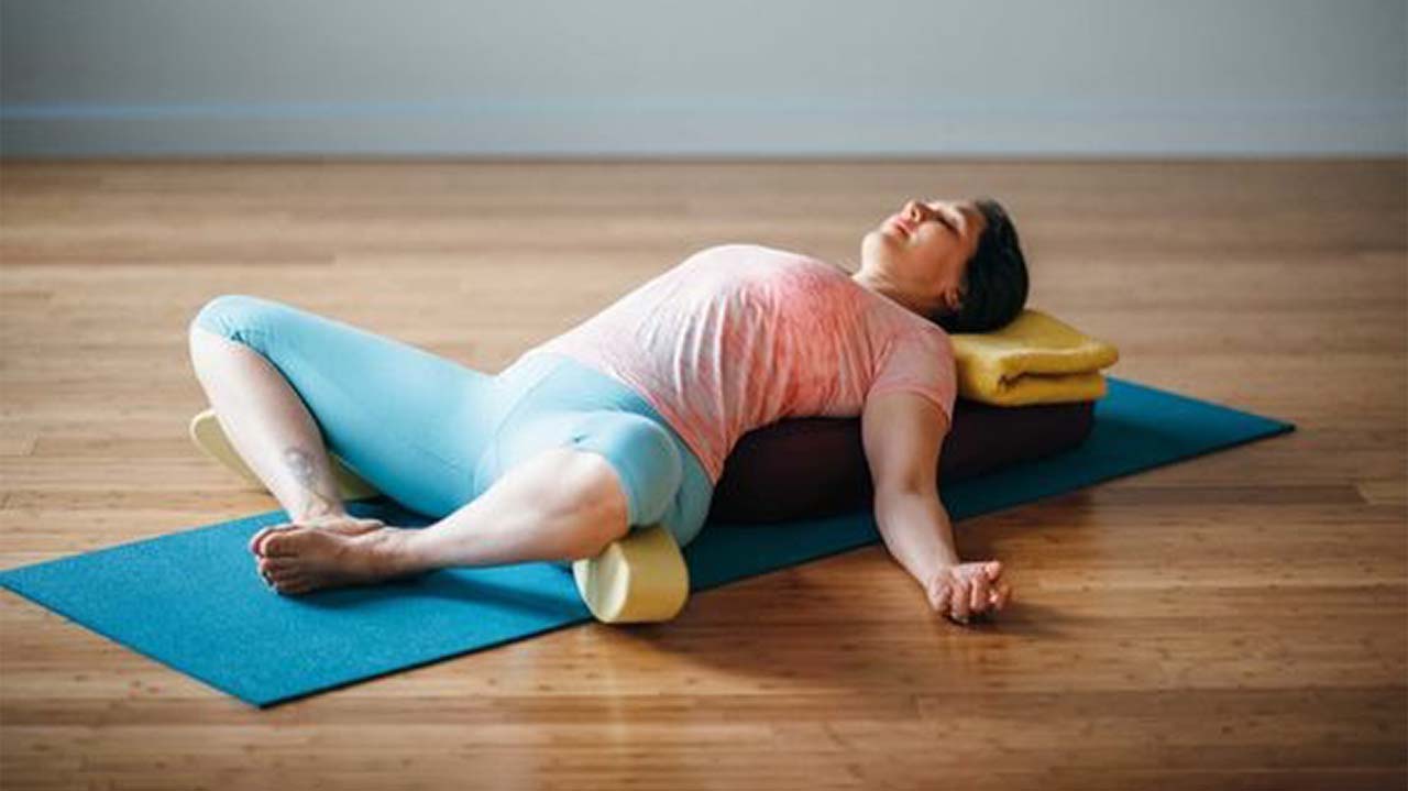 Reclined Bound Angle (or Cobbler's) Pose (Supta Baddha Konasana) is a deeply relaxing and restorative yoga pose.