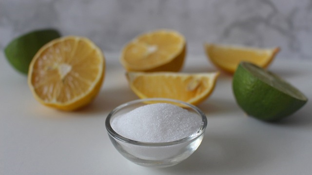 some salt in a cup and slices of lemon are placed on a table