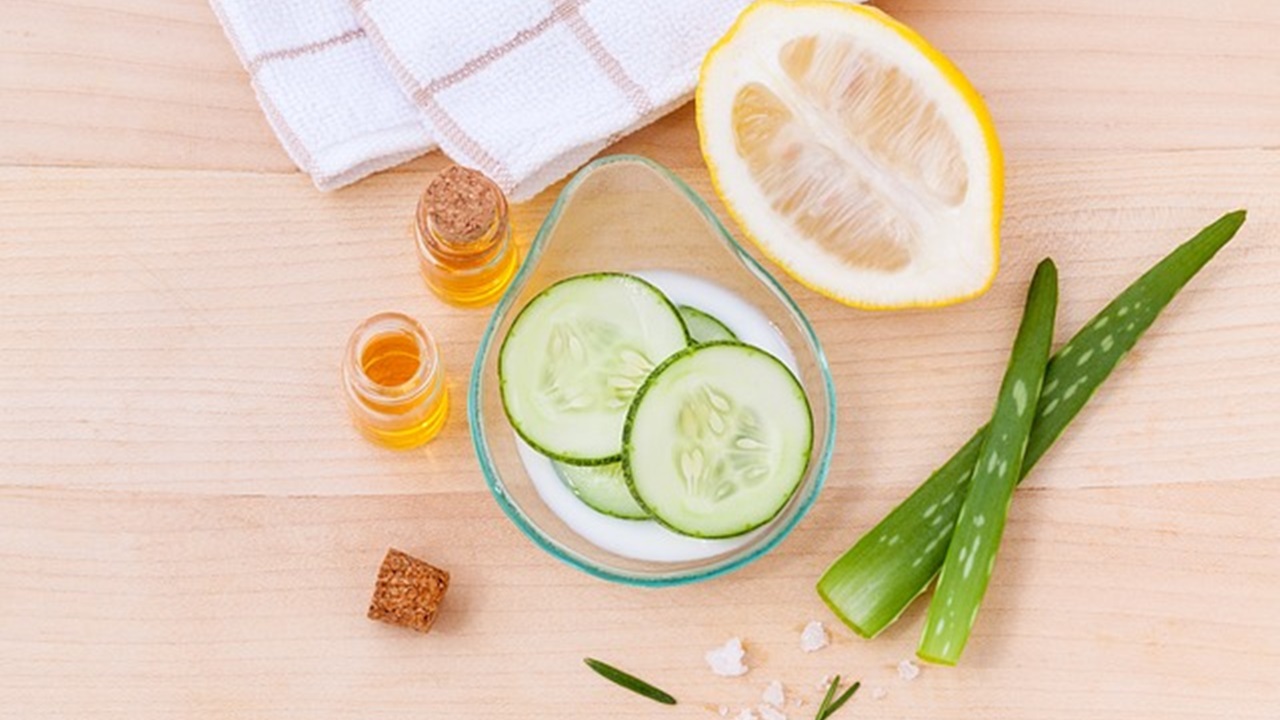 sliced cucumber, lemons and some essential oils