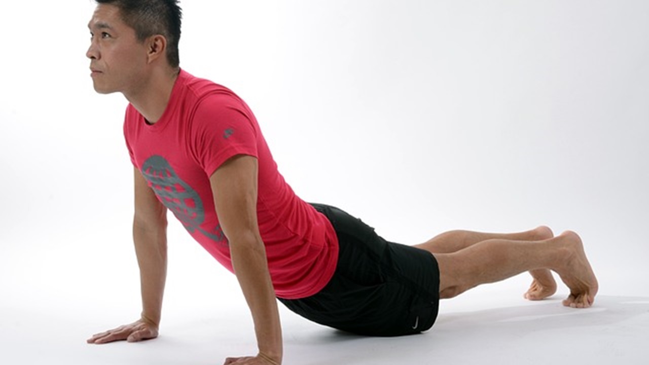 a man is doing spine stretch exercise