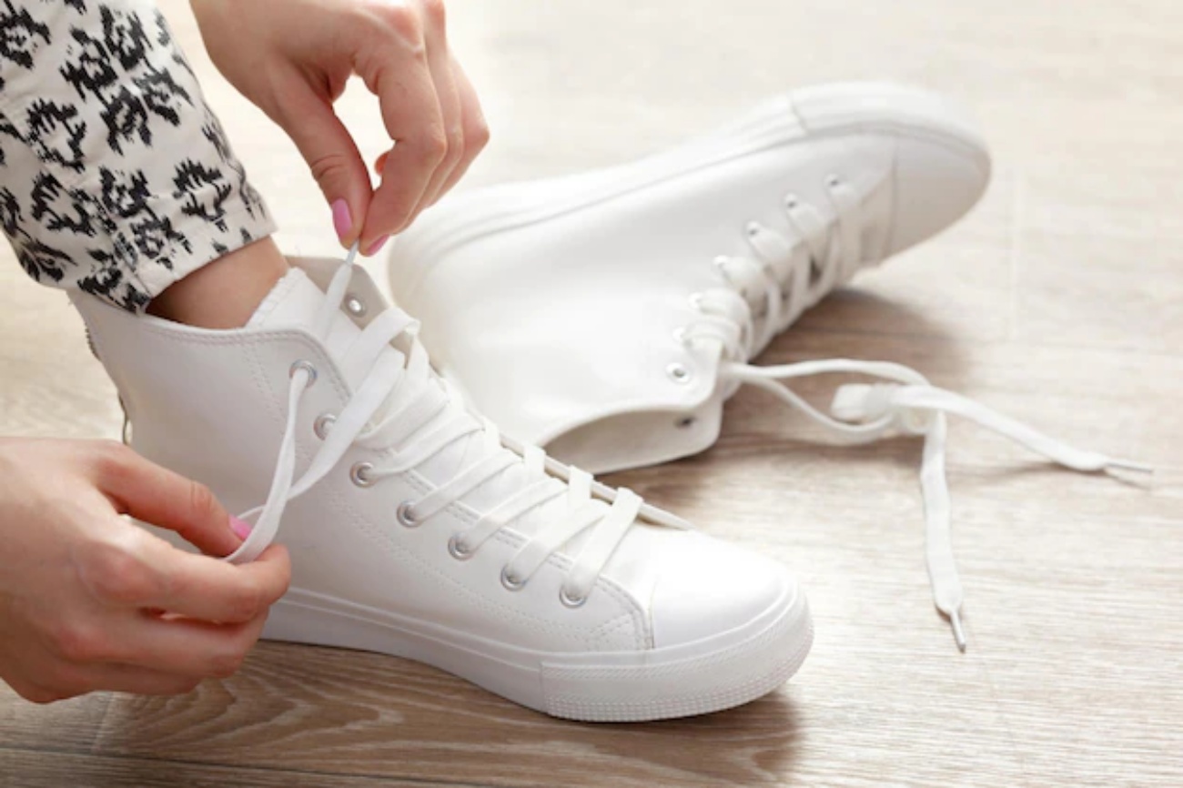 a girl is taking off her shoes