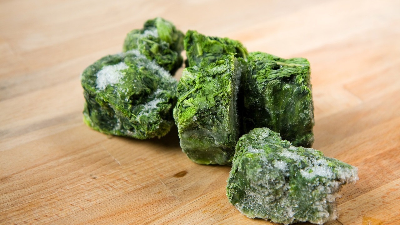 frozen spinach placed on the wooden table