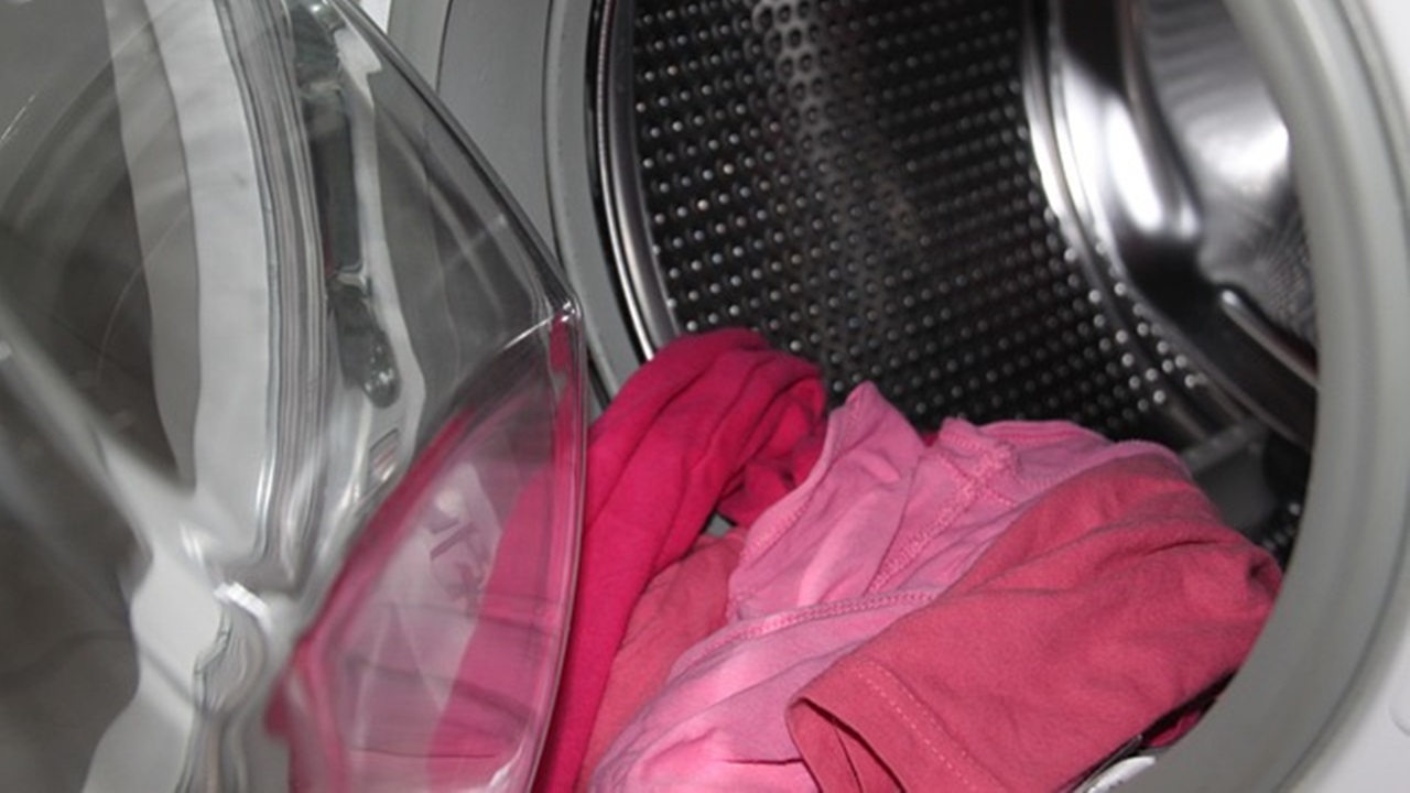 placing dirty clothes in the washing machine