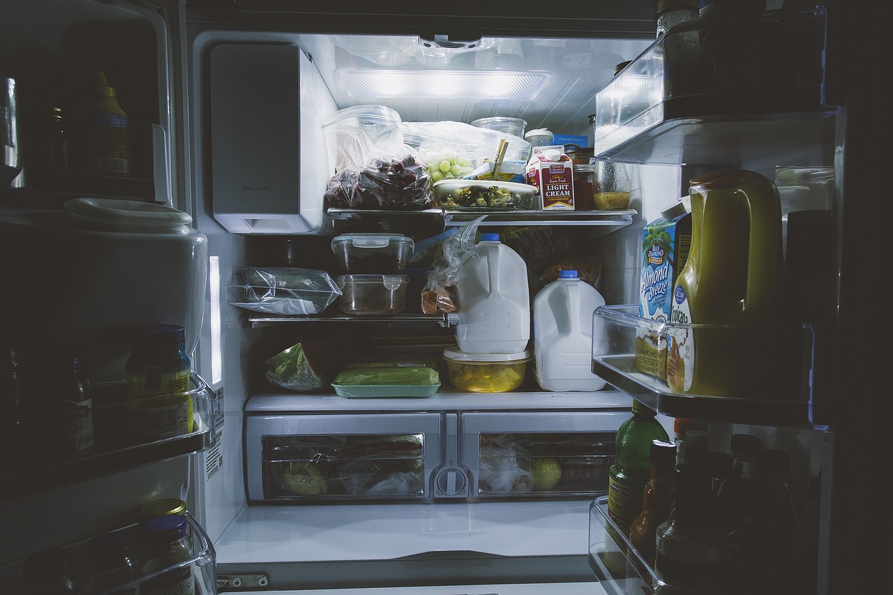 a fridge is filled with different foods.