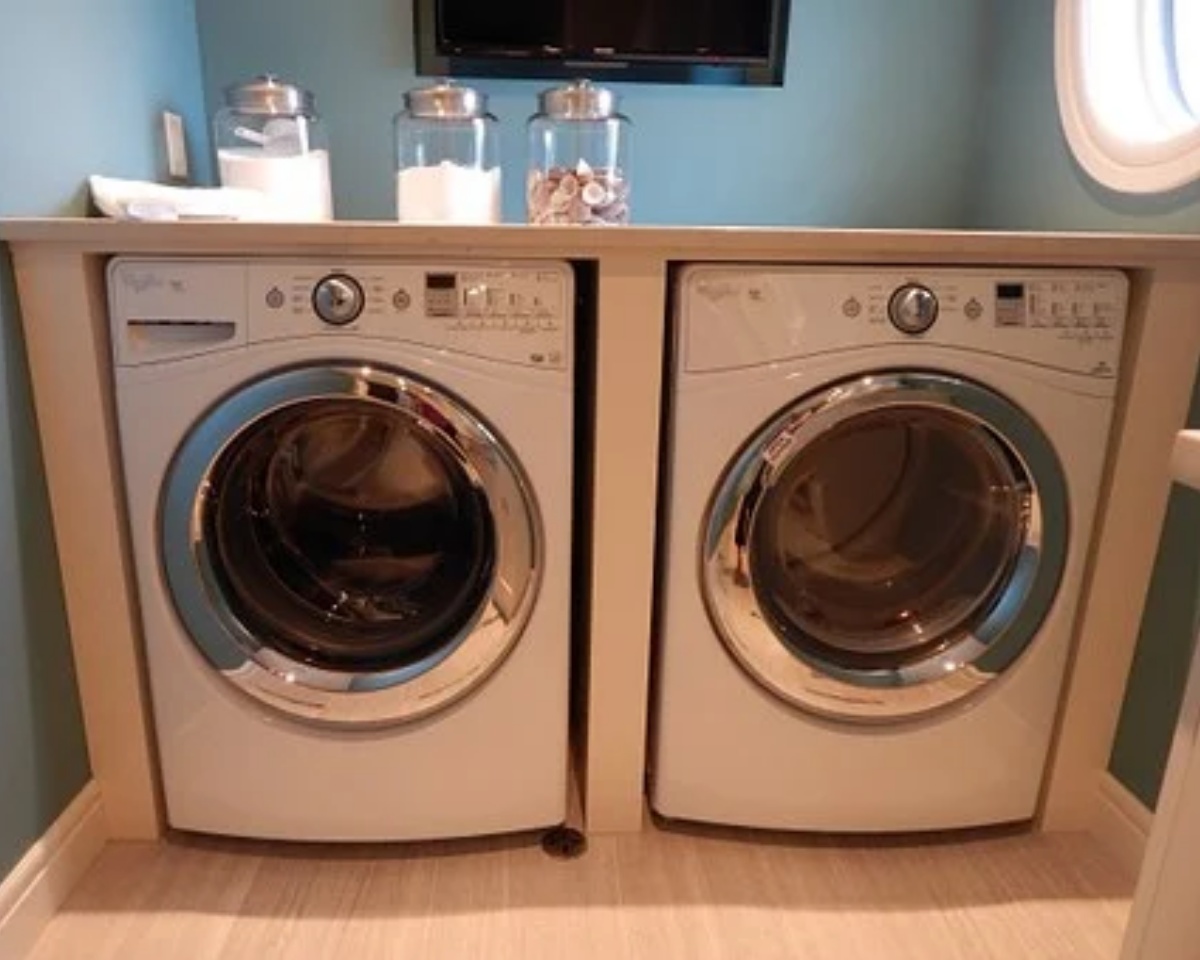 detergent and coin jars are placed on the washing machine in the laundry