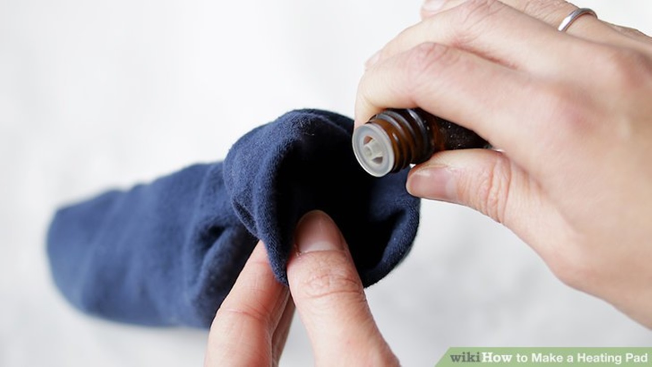 a women is putting a few drops of oil in a sock