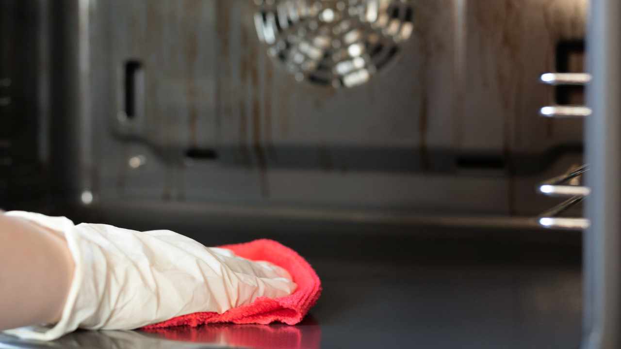 a person is cleaning oven