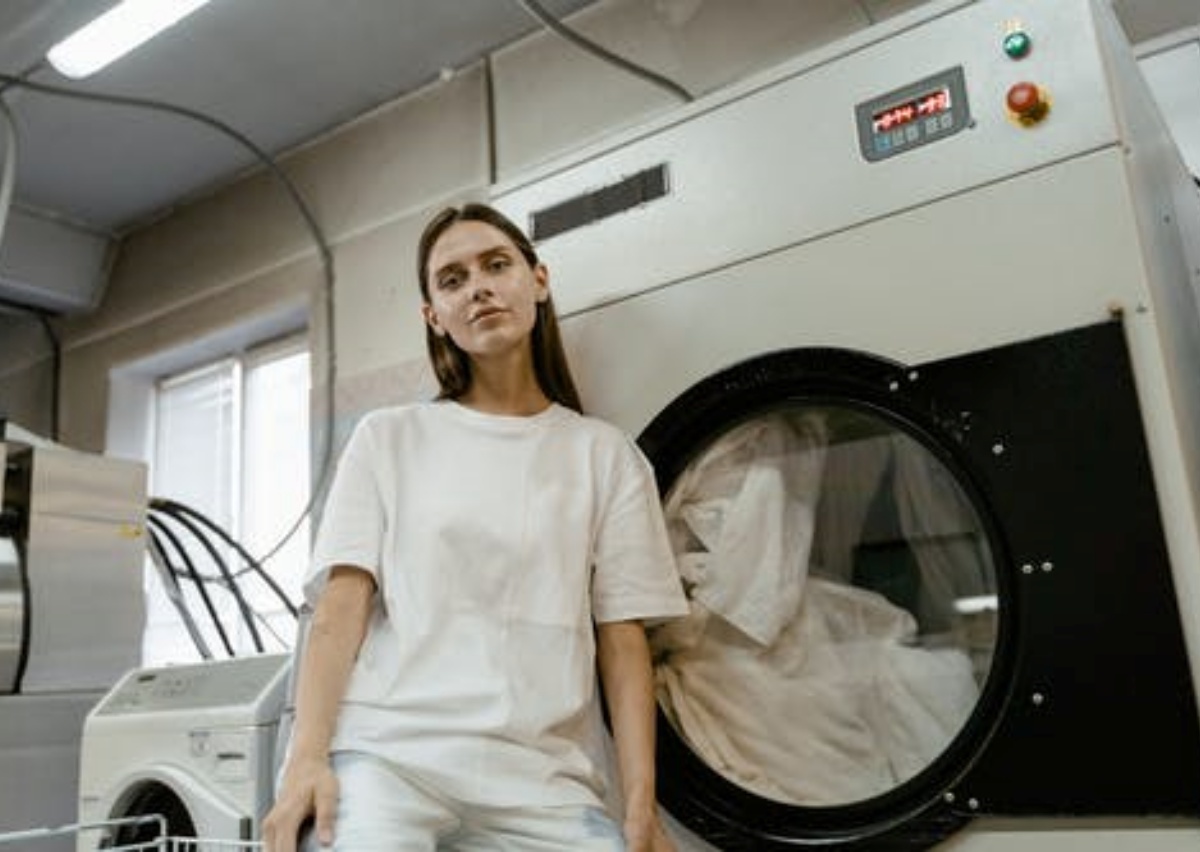 a girl is washing duvet in the laundry