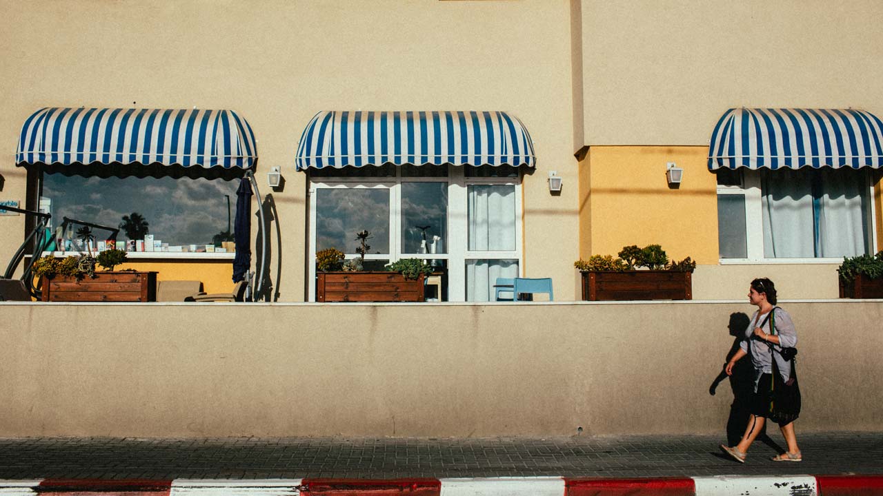 building with awnings next to the street