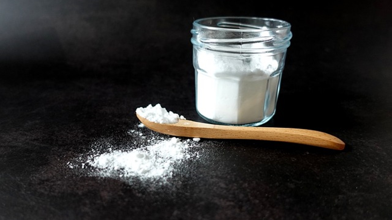 a small baking soda jar and a spoon