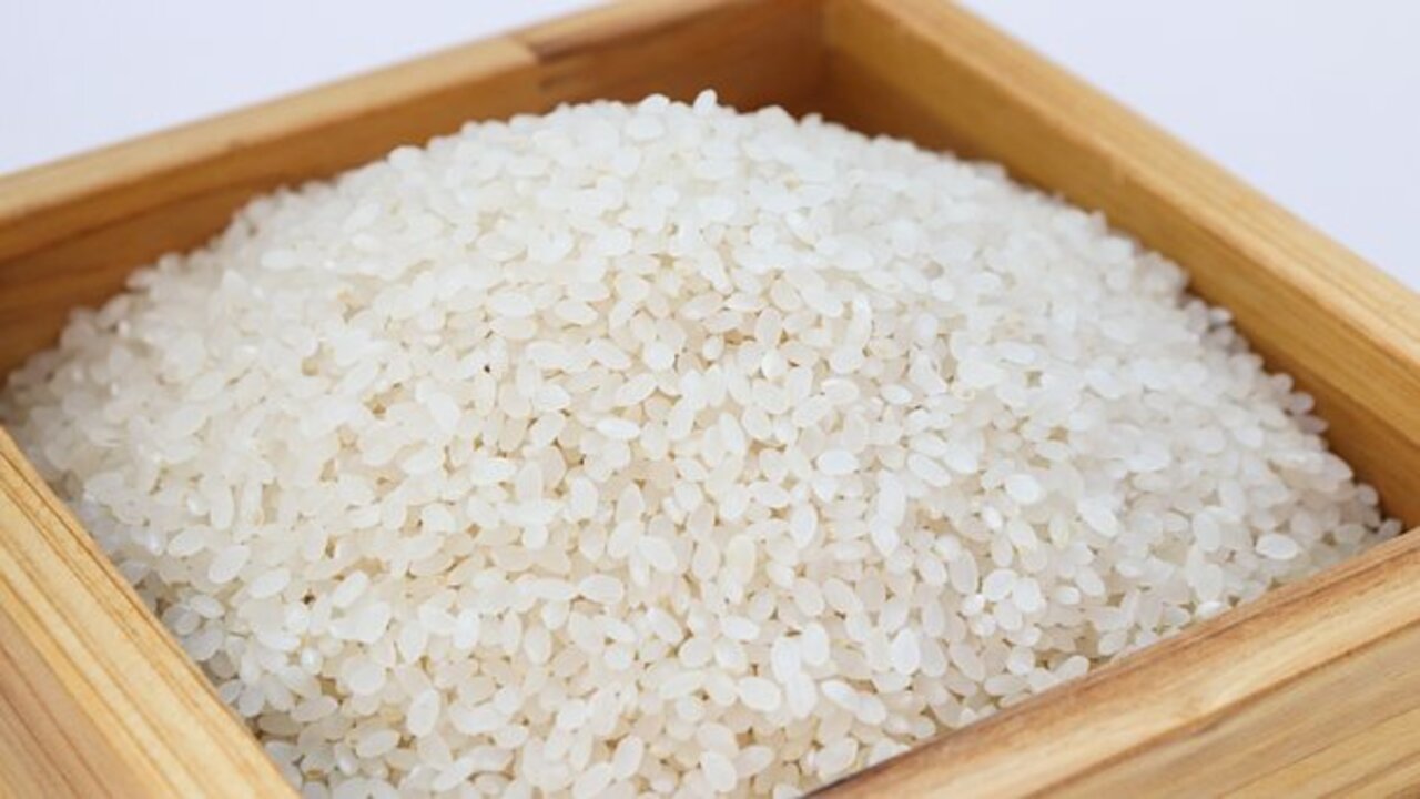 a bowl filled with rice is placed on the table