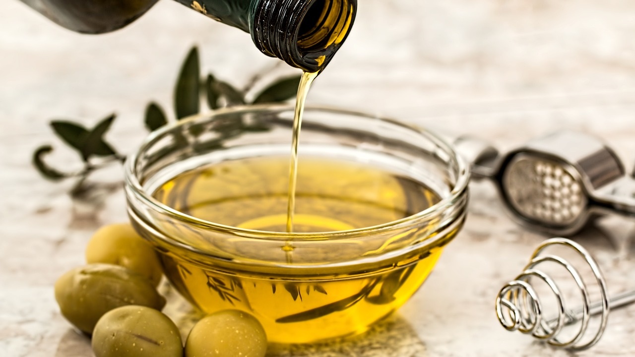 a person is pouring an essential oil in a small bowl