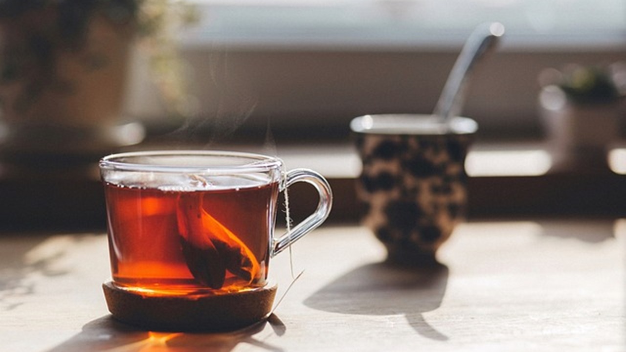 a cup of hot tea with a tea bag in it