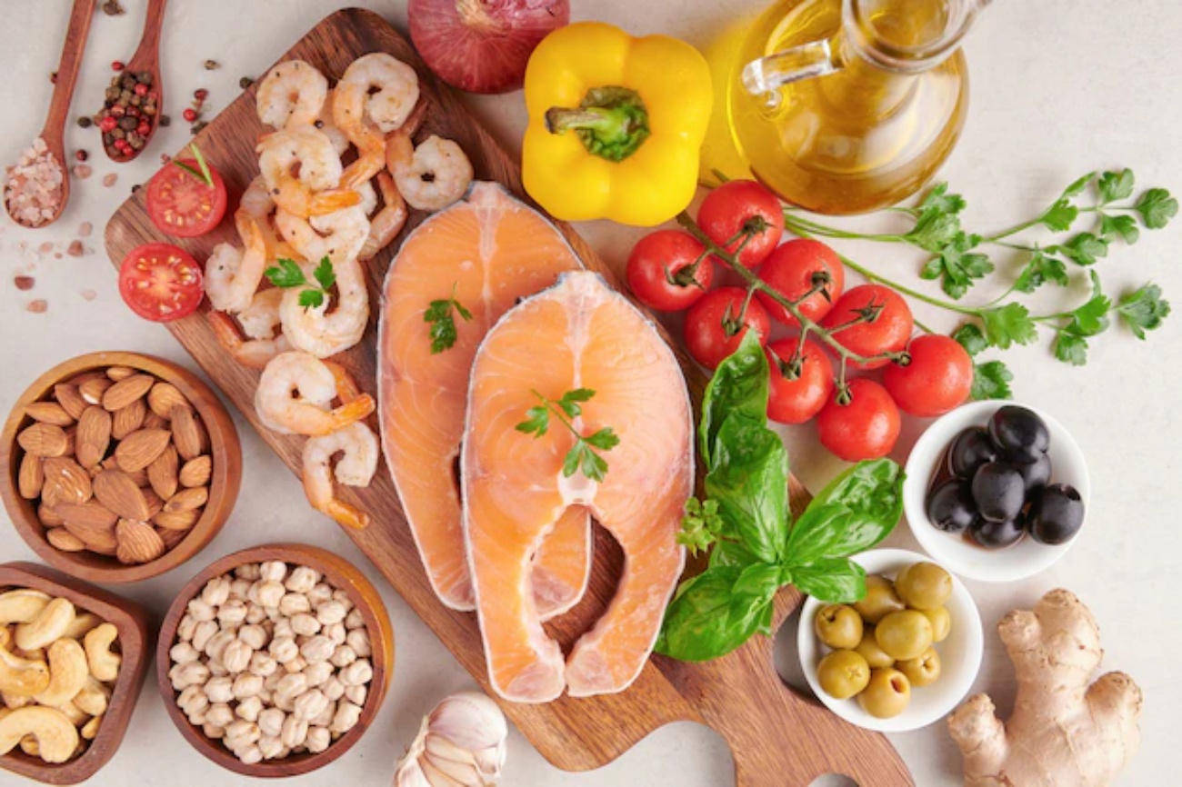 fish, prongs, dry fruits and vegetables are placed on a table beautifully