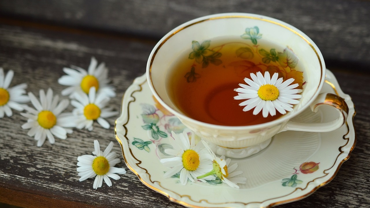 chamomile tea in a cup is placed on a table