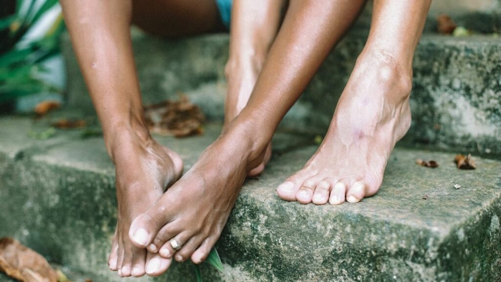 a women and a man are sitting on the stairs with bare foot