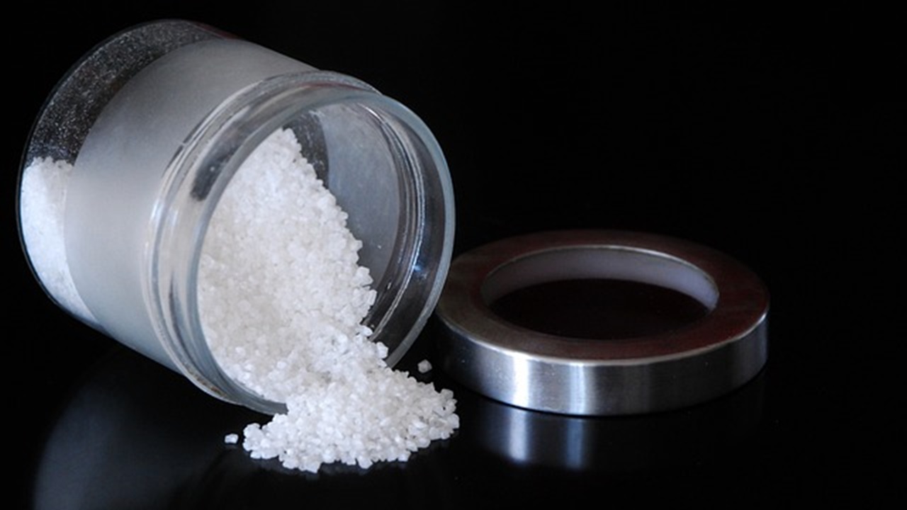 coarse salt in a jar is placed on the table