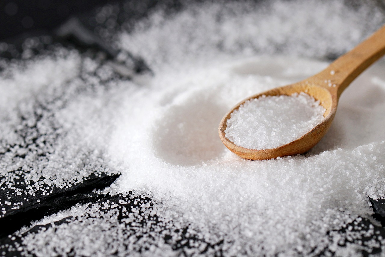 some salt is placed on the table and in the spoon