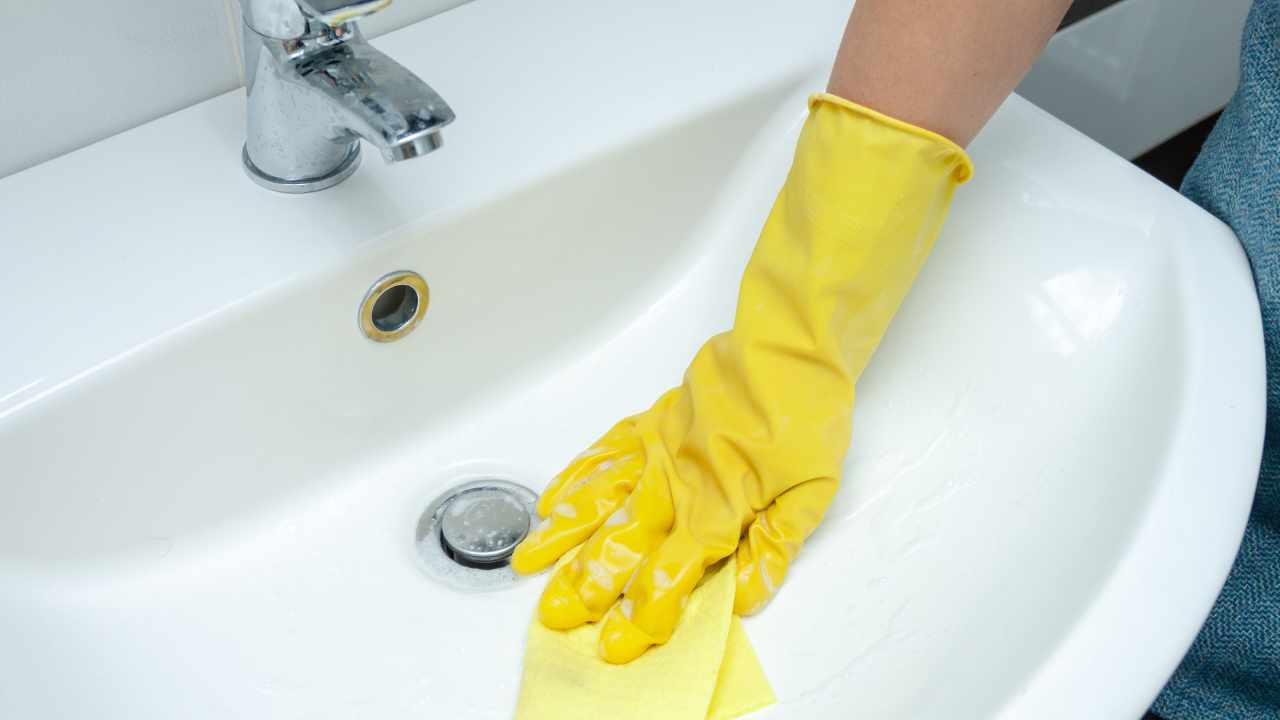 a person is cleaning the sink